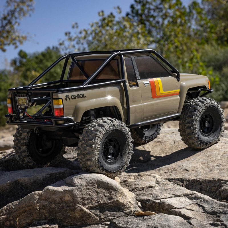 Axial SCX10 III 1987 Toyota Hilux crawling over rocks